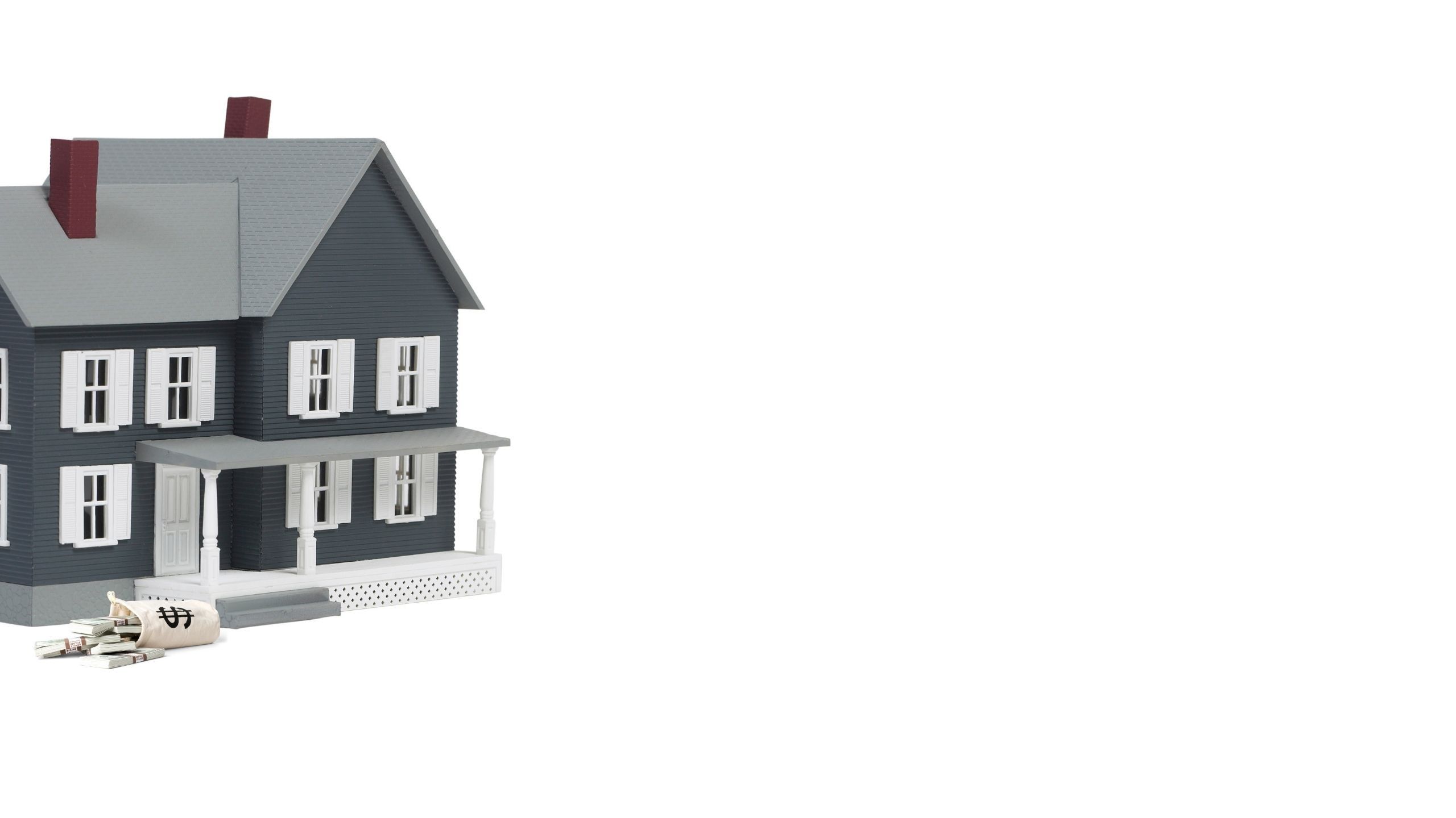Model of a two-storey house beside a set of house keys
